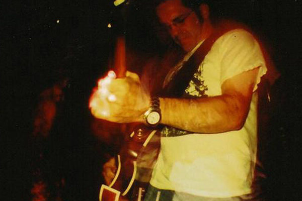 David Hillman playing electric guitar on stage